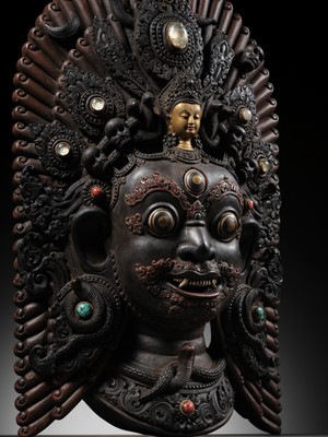 Lot 31 - A LARGE GEMSTONE-INLAID GILT AND POLYCHROME WOOD MASK OF BHAIRAVA, NEPAL, 19TH CENTURY OR EARLIER