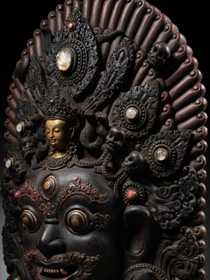 Lot 31 - A LARGE GEMSTONE-INLAID GILT AND POLYCHROME WOOD MASK OF BHAIRAVA, NEPAL, 19TH CENTURY OR EARLIER