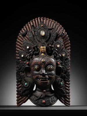 Lot 31 - A LARGE GEMSTONE-INLAID GILT AND POLYCHROME WOOD MASK OF BHAIRAVA, NEPAL, 19TH CENTURY OR EARLIER