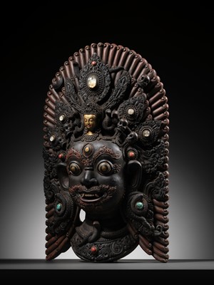 Lot 31 - A LARGE GEMSTONE-INLAID GILT AND POLYCHROME WOOD MASK OF BHAIRAVA, NEPAL, 19TH CENTURY OR EARLIER