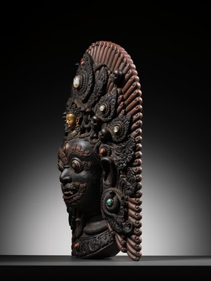 Lot 31 - A LARGE GEMSTONE-INLAID GILT AND POLYCHROME WOOD MASK OF BHAIRAVA, NEPAL, 19TH CENTURY OR EARLIER