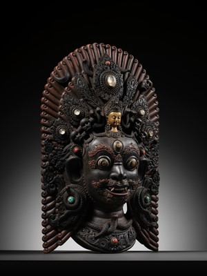 Lot 31 - A LARGE GEMSTONE-INLAID GILT AND POLYCHROME WOOD MASK OF BHAIRAVA, NEPAL, 19TH CENTURY OR EARLIER