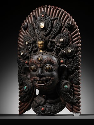 Lot 31 - A LARGE GEMSTONE-INLAID GILT AND POLYCHROME WOOD MASK OF BHAIRAVA, NEPAL, 19TH CENTURY OR EARLIER