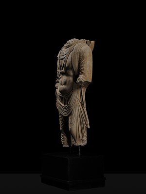 Lot 100 - A MONUMENTAL AND MASSIVE (820 KG) STONE TORSO OF A BODHISATTVA, KUSHAN PERIOD, ANCIENT REGION OF GANDHARA, CIRCA 3RD-4TH CENTURY