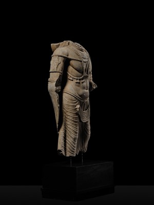 Lot 100 - A MONUMENTAL AND MASSIVE (820 KG) STONE TORSO OF A BODHISATTVA, KUSHAN PERIOD, ANCIENT REGION OF GANDHARA, CIRCA 3RD-4TH CENTURY