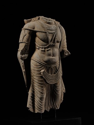 Lot 100 - A MONUMENTAL AND MASSIVE (820 KG) STONE TORSO OF A BODHISATTVA, KUSHAN PERIOD, ANCIENT REGION OF GANDHARA, CIRCA 3RD-4TH CENTURY