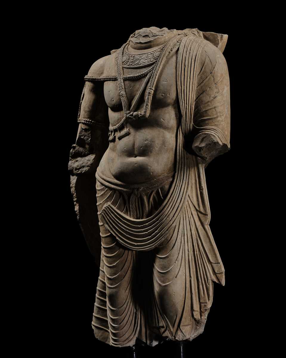 Lot 100 - A MONUMENTAL AND MASSIVE (820 KG) STONE TORSO OF A BODHISATTVA, KUSHAN PERIOD, ANCIENT REGION OF GANDHARA, CIRCA 3RD-4TH CENTURY