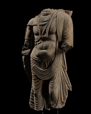 Lot 100 - A MONUMENTAL AND MASSIVE (820 KG) STONE TORSO OF A BODHISATTVA, KUSHAN PERIOD, ANCIENT REGION OF GANDHARA, CIRCA 3RD-4TH CENTURY