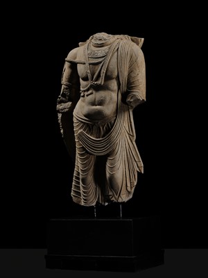 Lot 100 - A MONUMENTAL AND MASSIVE (820 KG) STONE TORSO OF A BODHISATTVA, KUSHAN PERIOD, ANCIENT REGION OF GANDHARA, CIRCA 3RD-4TH CENTURY