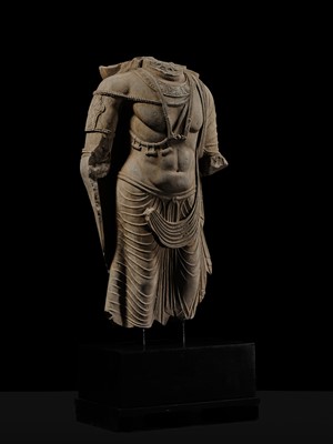 Lot 100 - A MONUMENTAL AND MASSIVE (820 KG) STONE TORSO OF A BODHISATTVA, KUSHAN PERIOD, ANCIENT REGION OF GANDHARA, CIRCA 3RD-4TH CENTURY