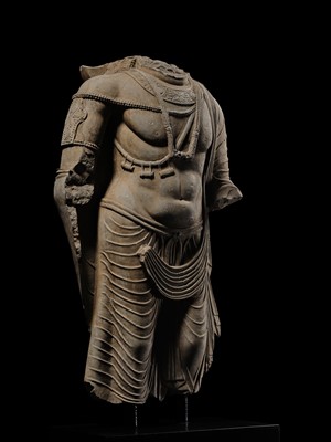 Lot 100 - A MONUMENTAL AND MASSIVE (820 KG) STONE TORSO OF A BODHISATTVA, KUSHAN PERIOD, ANCIENT REGION OF GANDHARA, CIRCA 3RD-4TH CENTURY