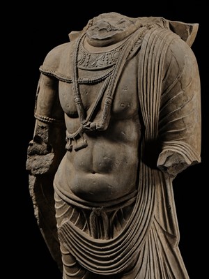 Lot 100 - A MONUMENTAL AND MASSIVE (820 KG) STONE TORSO OF A BODHISATTVA, KUSHAN PERIOD, ANCIENT REGION OF GANDHARA, CIRCA 3RD-4TH CENTURY