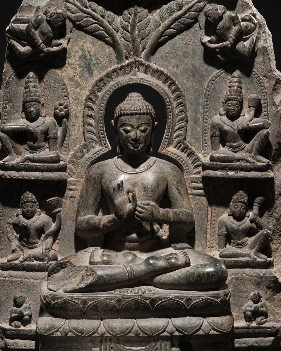 Lot 68 - A RARE AND IMPORTANT BLACK STONE STELE OF BUDDHA PREACHING THE FIRST SERMON AT SARNATH, PROBABLY RATNAGIRI, 9TH-12TH CENTURY