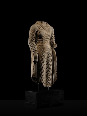Lot 58 - A RARE AND MONUMENTAL (175 CM HIGH) GRAY SCHIST TORSO OF BUDDHA SHAKYAMUNI, KUSHAN PERIOD, ANCIENT REGION OF GANDHARA, CIRCA 2ND-3RD CENTURY