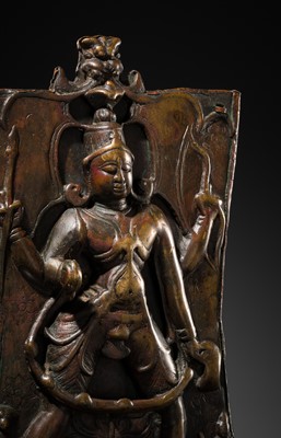 Lot 75 - A BRONZE CEREMONIAL SHIELD DEPICTING VIRABHADRA, SOUTH INDIA, 16TH-17TH CENTURY