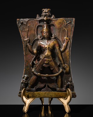 Lot 75 - A BRONZE CEREMONIAL SHIELD DEPICTING VIRABHADRA, SOUTH INDIA, 16TH-17TH CENTURY