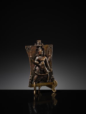 Lot 75 - A BRONZE CEREMONIAL SHIELD DEPICTING VIRABHADRA, SOUTH INDIA, 16TH-17TH CENTURY