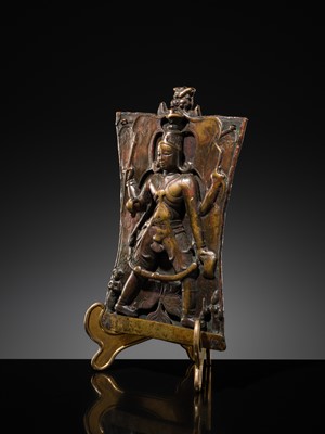 Lot 75 - A BRONZE CEREMONIAL SHIELD DEPICTING VIRABHADRA, SOUTH INDIA, 16TH-17TH CENTURY