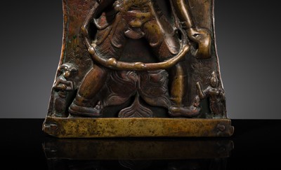 Lot 75 - A BRONZE CEREMONIAL SHIELD DEPICTING VIRABHADRA, SOUTH INDIA, 16TH-17TH CENTURY