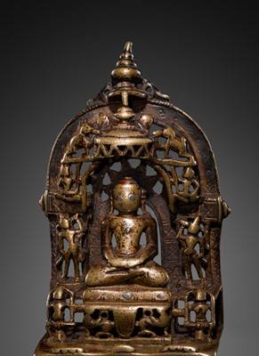 Lot 73 - A JAIN COPPER- AND SILVER-INLAID BRASS SHRINE OF A TIRTHANKARA, DATED 1325