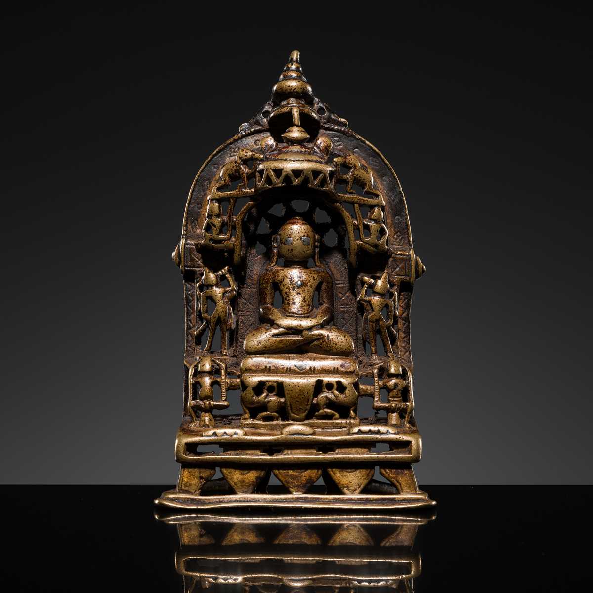 Lot 73 - A JAIN COPPER- AND SILVER-INLAID BRASS SHRINE OF A TIRTHANKARA, DATED 1325