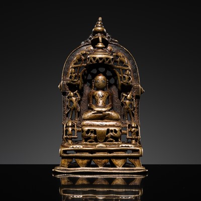 Lot 73 - A JAIN COPPER- AND SILVER-INLAID BRASS SHRINE OF A TIRTHANKARA, DATED 1325