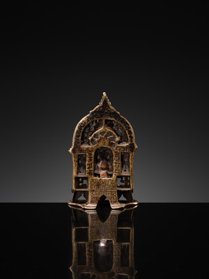 Lot 73 - A JAIN COPPER- AND SILVER-INLAID BRASS SHRINE OF A TIRTHANKARA, DATED 1325