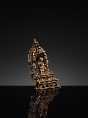 Lot 73 - A JAIN COPPER- AND SILVER-INLAID BRASS SHRINE OF A TIRTHANKARA, DATED 1325