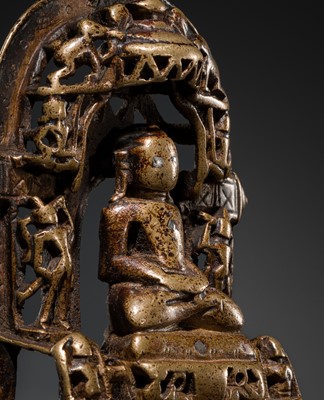 Lot 73 - A JAIN COPPER- AND SILVER-INLAID BRASS SHRINE OF A TIRTHANKARA, DATED 1325