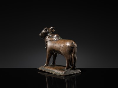 Lot 72 - A SILVER-INLAID BRONZE FIGURE OF NANDI, HIMACHAL PRADESH, 10TH CENTURY