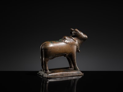 Lot 72 - A SILVER-INLAID BRONZE FIGURE OF NANDI, HIMACHAL PRADESH, 10TH CENTURY