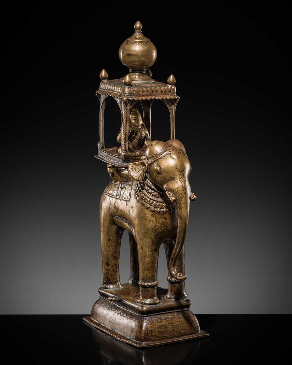 Lot 76 - A BRONZE MODEL OF AN ELEPHANT WITH CANOPY CONTAINING A BRASS FIGURE OF MALE DEITY, DECCAN, 17TH CENTURY