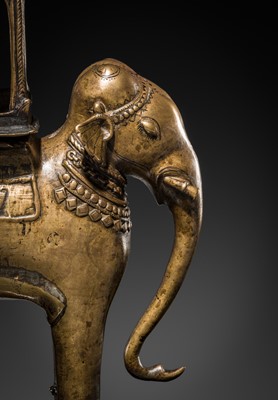 Lot 76 - A BRONZE MODEL OF AN ELEPHANT WITH CANOPY CONTAINING A BRASS FIGURE OF MALE DEITY, DECCAN, 17TH CENTURY