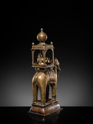 Lot 76 - A BRONZE MODEL OF AN ELEPHANT WITH CANOPY CONTAINING A BRASS FIGURE OF MALE DEITY, DECCAN, 17TH CENTURY