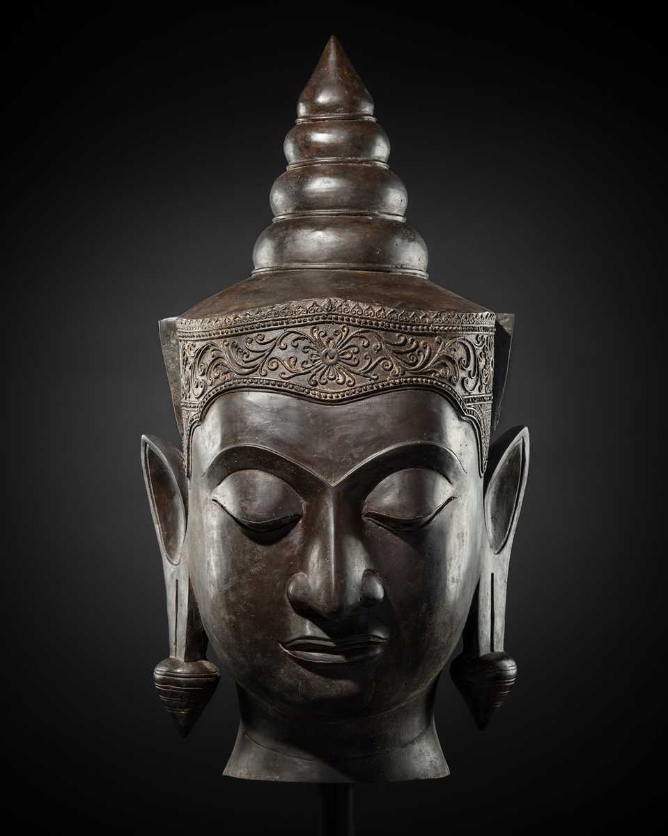 Lot 35 - A MONUMENTAL (88 CM HIGH) BRONZE HEAD OF CROWNED BUDDHA, PHRA CHAO SONG KHRUANG (‘A LORD WEARING ORNAMENTS’), AYUTTHAYA PERIOD