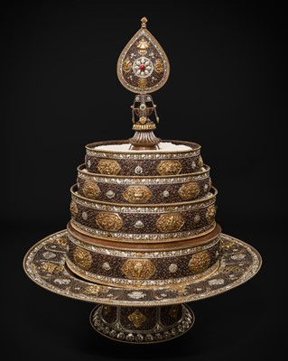 Lot 47 - A MONUMENTAL (142 CM) PARCEL-GILT COPPER AND SILVER REPOUSSÉ GRAIN MANDALA SET, TIBET, 20TH CENTURY