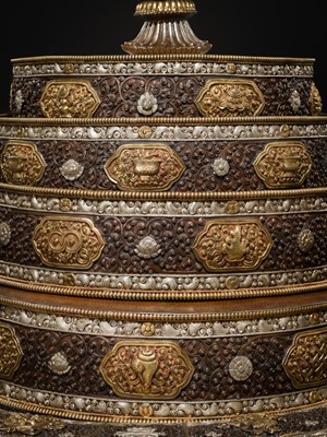 Lot 47 - A MONUMENTAL (142 CM) PARCEL-GILT COPPER AND SILVER REPOUSSÉ GRAIN MANDALA SET, TIBET, 20TH CENTURY