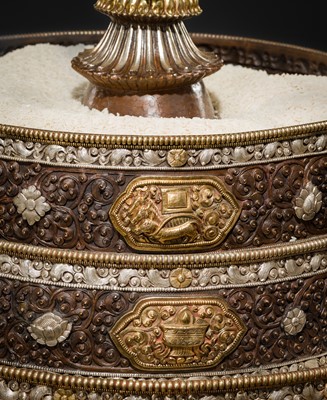 Lot 47 - A MONUMENTAL (142 CM) PARCEL-GILT COPPER AND SILVER REPOUSSÉ GRAIN MANDALA SET, TIBET, 20TH CENTURY