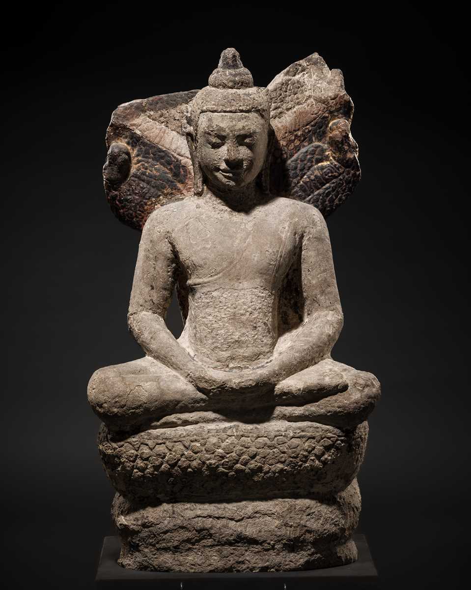Lot 24 - A RARE SANDSTONE FIGURE OF BUDDHA MUCHALINDA, LOPBURI STYLE, 13TH CENTURY