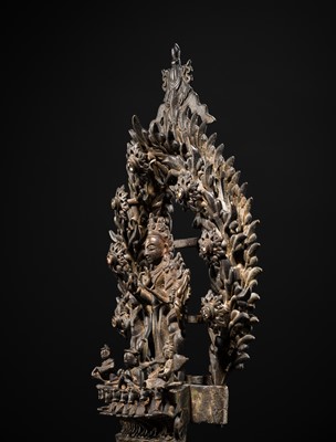 Lot 113 - A LARGE BRONZE TEMPLE LAMP DEPICTING SURYA ATOP HIS CHARIOT, NEPAL, 18TH CENTURY