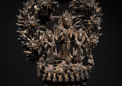 Lot 113 - A LARGE BRONZE TEMPLE LAMP DEPICTING SURYA ATOP HIS CHARIOT, NEPAL, 18TH CENTURY