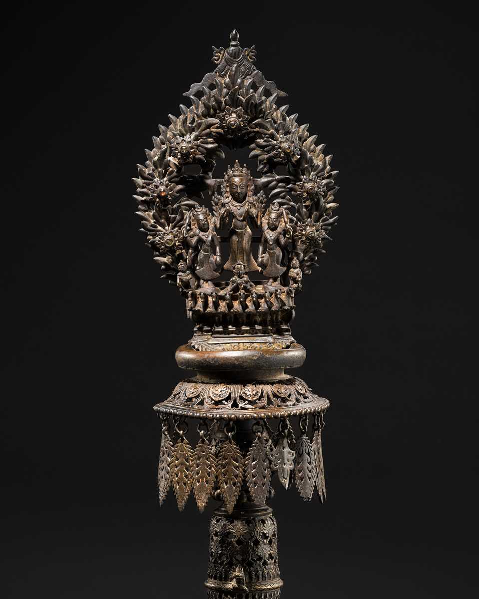 Lot 113 - A LARGE BRONZE TEMPLE LAMP DEPICTING SURYA ATOP HIS CHARIOT, NEPAL, 18TH CENTURY