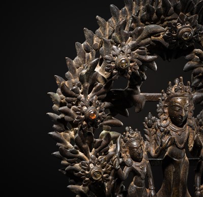 Lot 113 - A LARGE BRONZE TEMPLE LAMP DEPICTING SURYA ATOP HIS CHARIOT, NEPAL, 18TH CENTURY