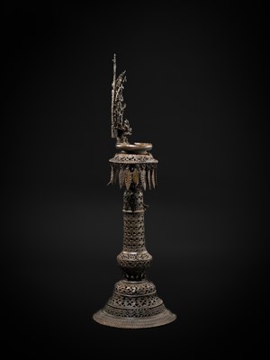 Lot 113 - A LARGE BRONZE TEMPLE LAMP DEPICTING SURYA ATOP HIS CHARIOT, NEPAL, 18TH CENTURY