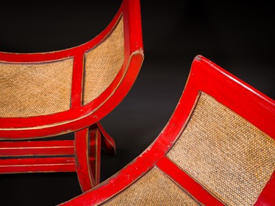 Lot 155 - A PAIR OF RED-LACQUERED WOOD AND RATTAN KARTINI STOOLS