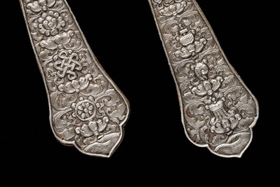 Lot 24 - A PAIR OF SILVER REPOUSSÉ FITTINGS, TIBET, 19TH CENTURY