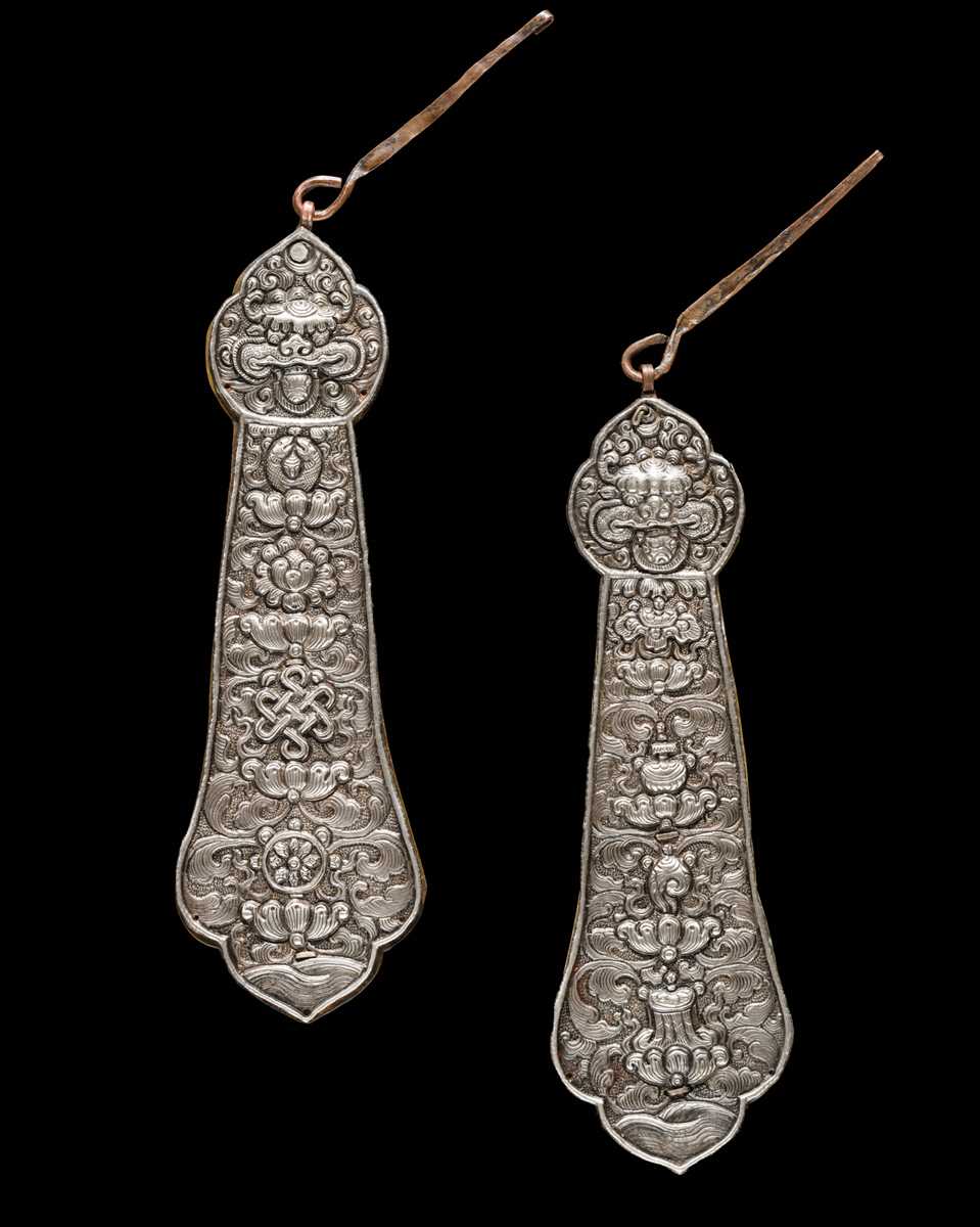 Lot 24 - A PAIR OF SILVER REPOUSSÉ FITTINGS, TIBET, 19TH CENTURY