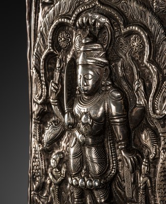 Lot 107 - A COPPER CEREMONIAL SHIELD WITH SILVER REPOUSSÉ PLAQUE DEPICTING VIRABHADRA, INDIA, 19TH CENTURY