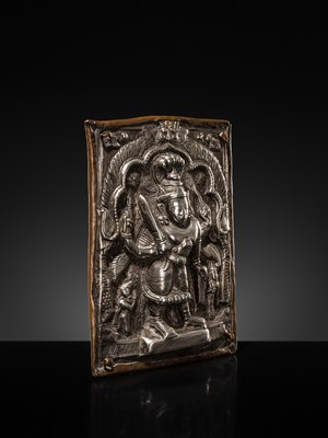 Lot 107 - A COPPER CEREMONIAL SHIELD WITH SILVER REPOUSSÉ PLAQUE DEPICTING VIRABHADRA, INDIA, 19TH CENTURY