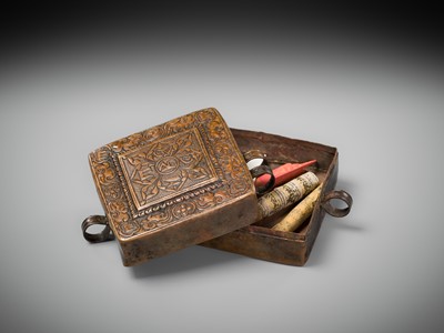 Lot 48 - A COPPER REPOUSSÉ AMULET BOX AND COVER, GAU, WITH SUTRA ROLLS AND RITUAL OBJECTS, 18TH-19TH CENTURY